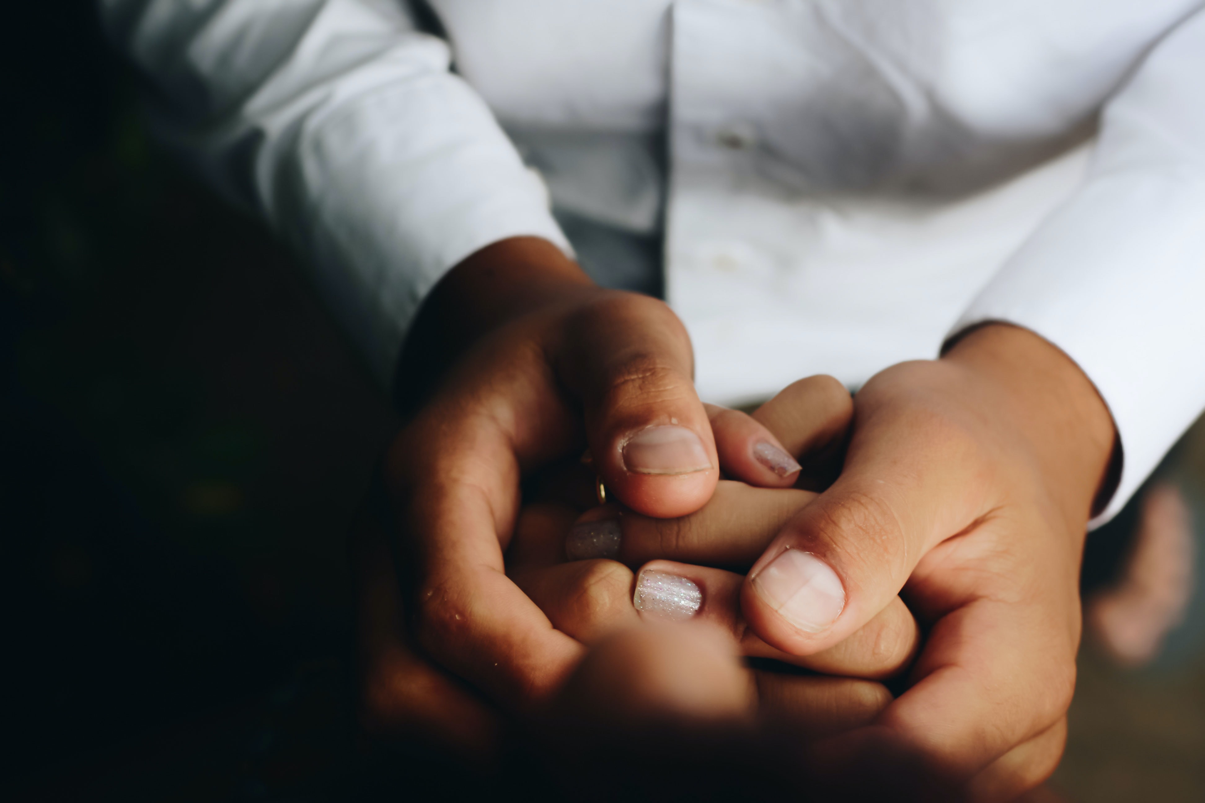 People holding hands; image by Matheus Ferrero, via Unsplash.com.