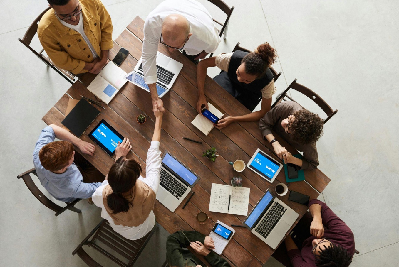 People ending a meeting with handshakes; image by Fauxels, via Pexels.com.